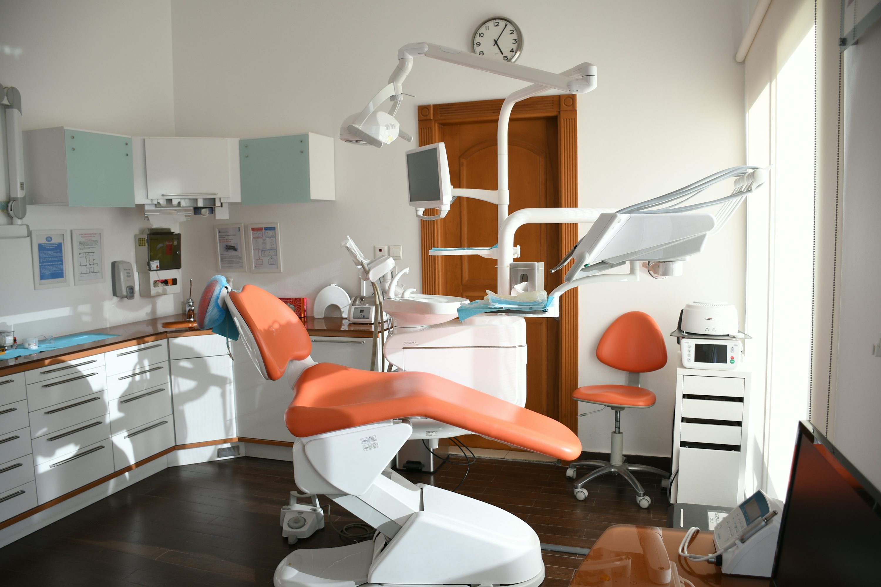 A smiling dental professional with a patient in a modern clinic.