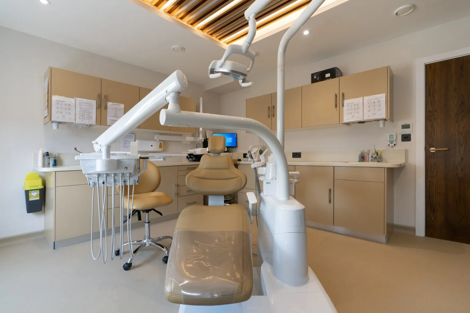 Modern dental clinic reception with a welcoming staff member.